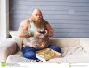 fat-man-entertaining-home-thick-guy-playing-console-aspiration-sitting-couch-near-unhealthy-fo...jpg